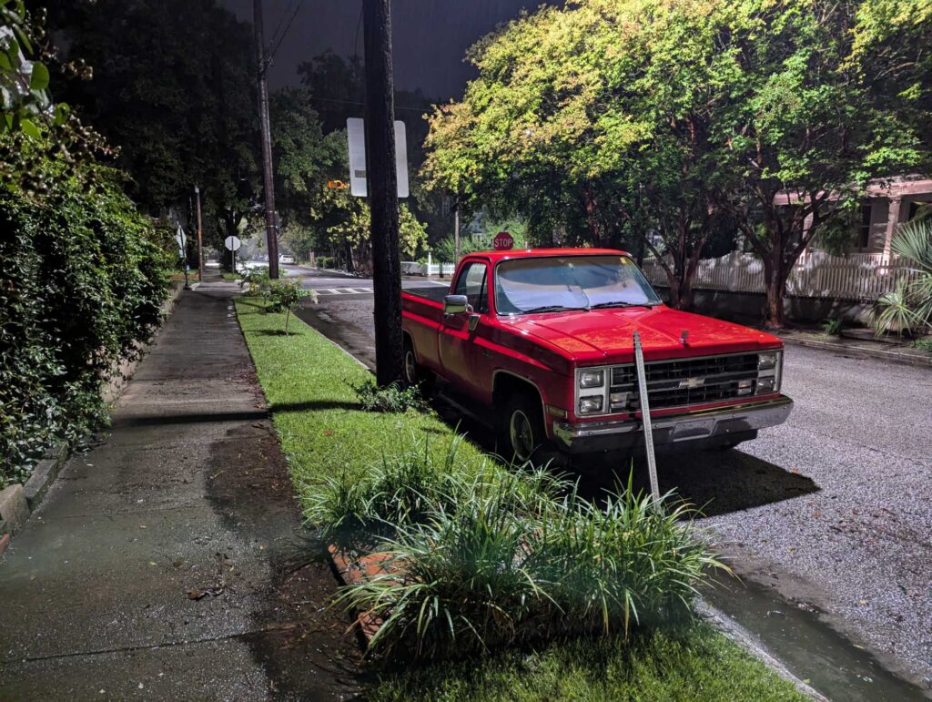 a red truck parked on the side of a road (MyCoast AI)