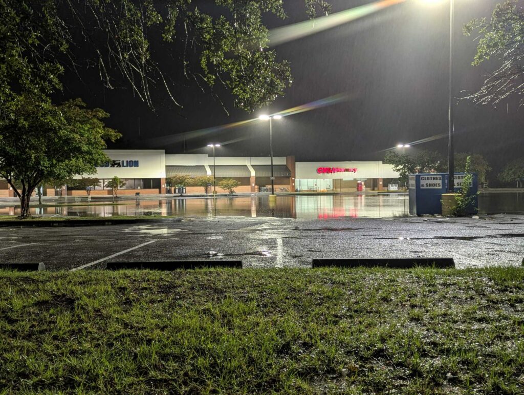 a building with a parking lot at night (MyCoast AI)