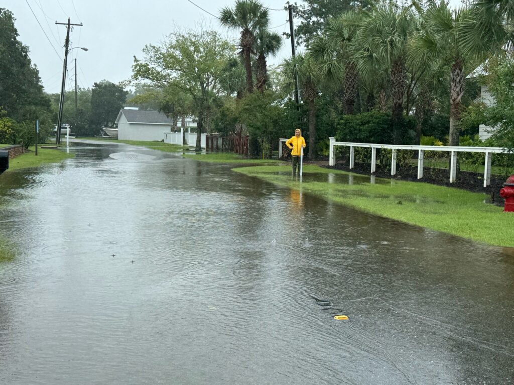 a person standing in a flooded street (MyCoast AI)