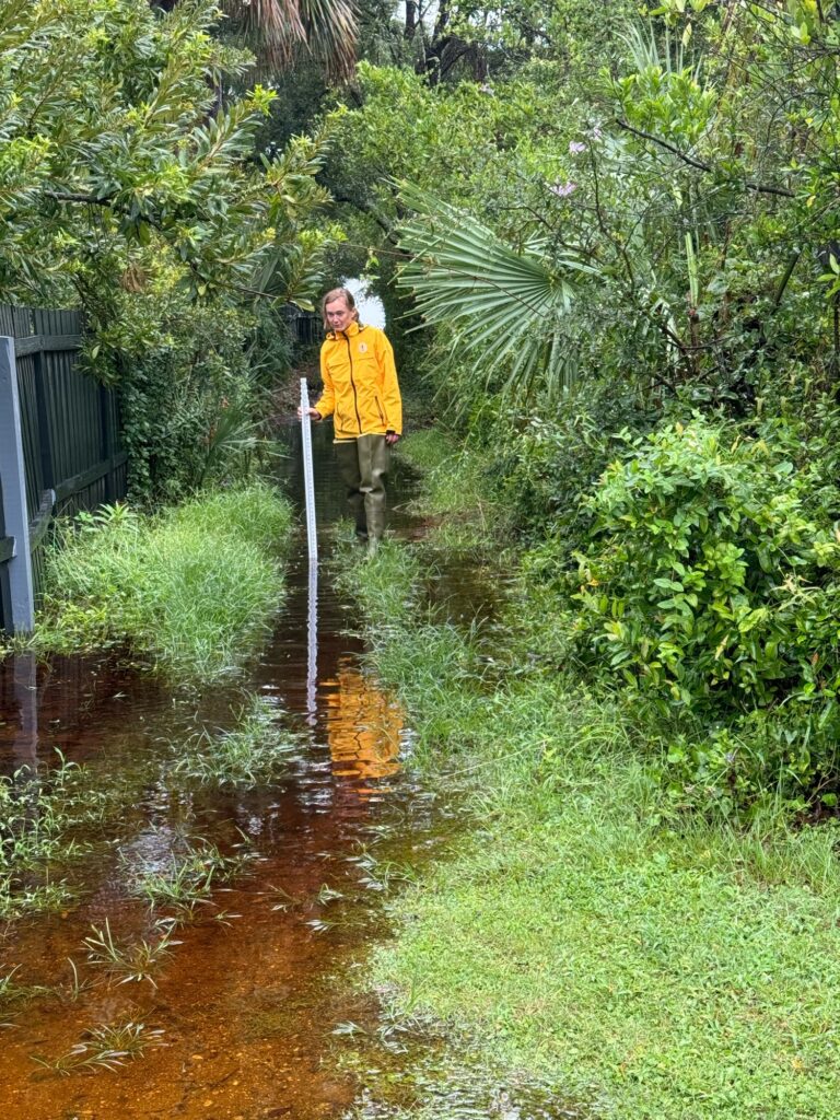 a person standing in a muddy puddle (MyCoast AI)