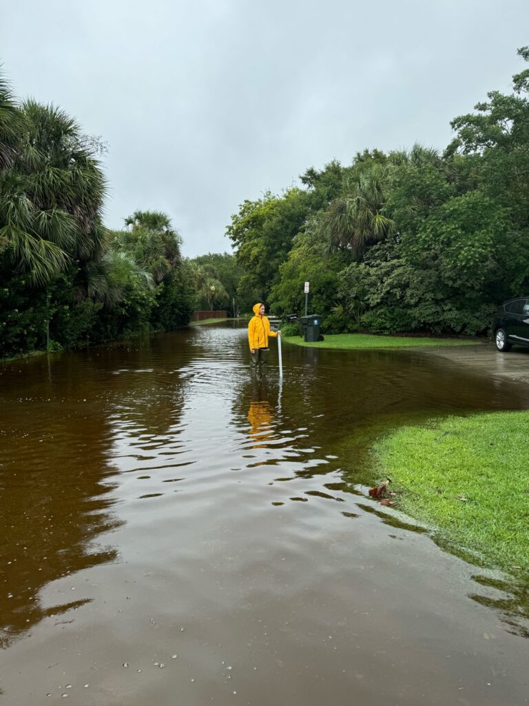 a person in a yellow raincoat in a flooded street (MyCoast AI)