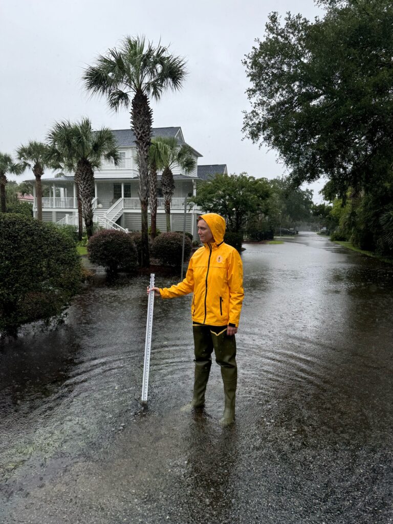 a man in a raincoat holding a cane (MyCoast AI)