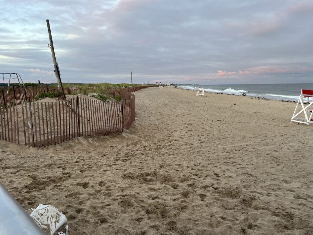 a sandy beach with a fence (MyCoast AI)