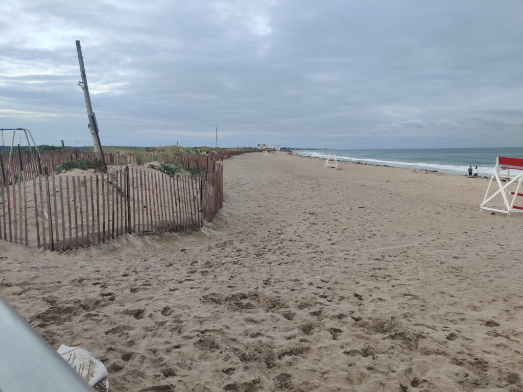 a sandy beach with a fence (MyCoast AI)