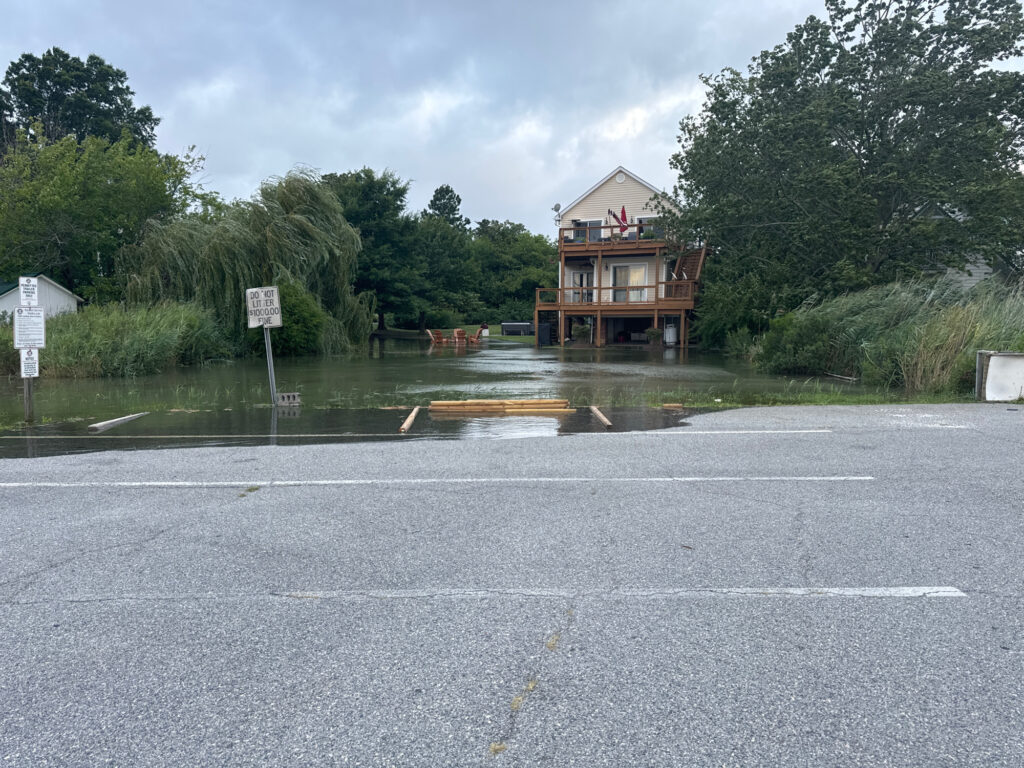 a flooded road with a house (MyCoast AI)