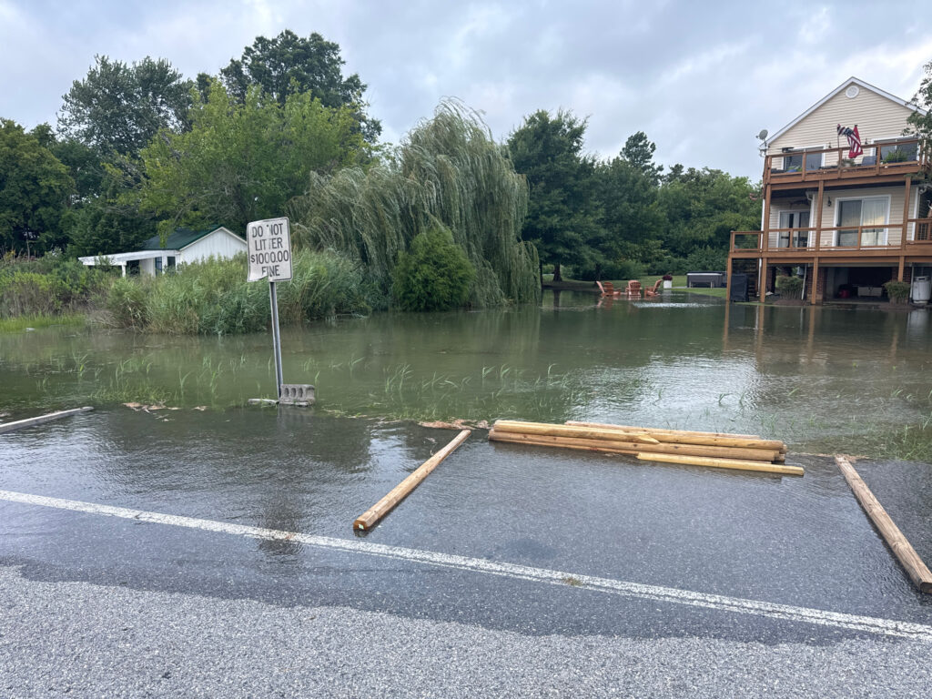 a flooded area with a building and trees in the background (MyCoast AI)