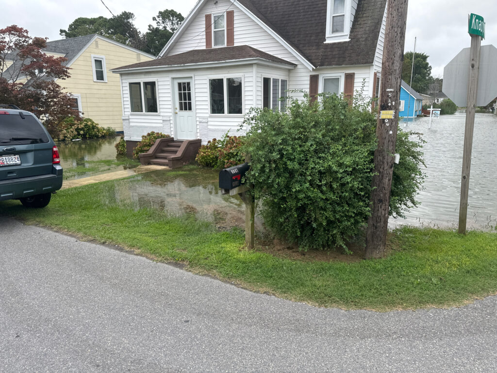 a house with a driveway and a car parked in front (MyCoast AI)