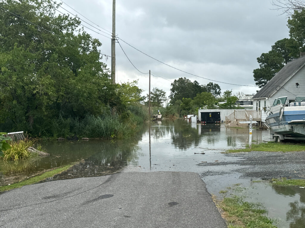 a flooded street with a bus and a house (MyCoast AI)
