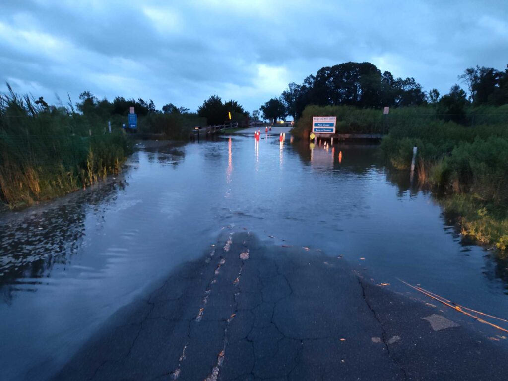 a flooded road with a sign (MyCoast AI)
