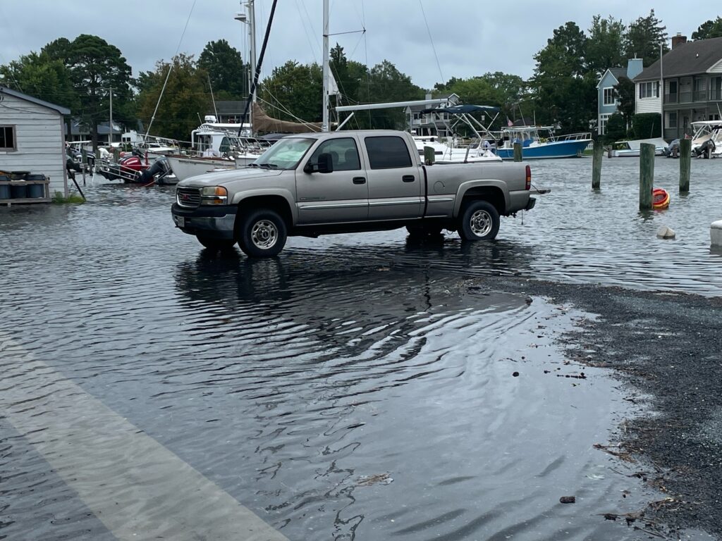 a truck driving through a flooded street (MyCoast AI)