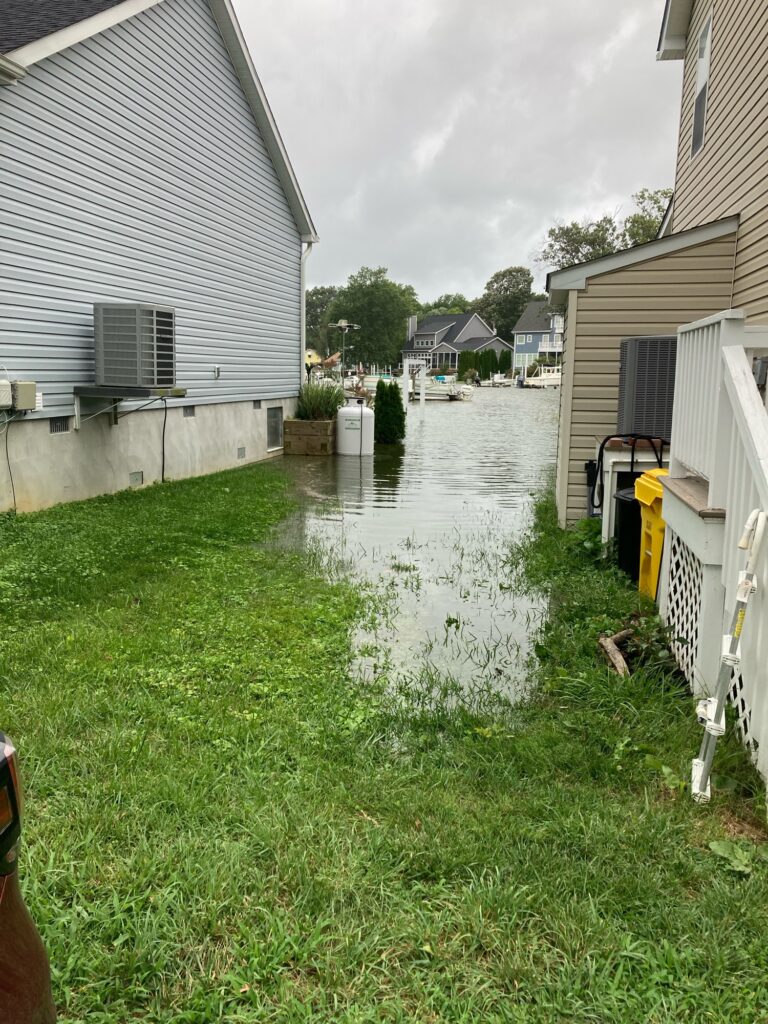 a flooded street between buildings (MyCoast AI)
