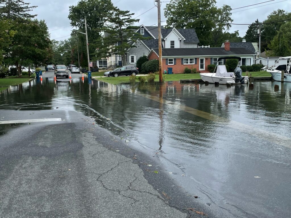 a flooded street with boats and houses (MyCoast AI)