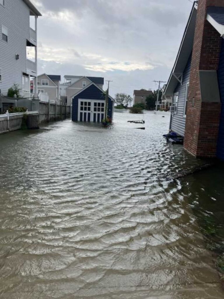 a flooded street with buildings on either side of it (MyCoast AI)