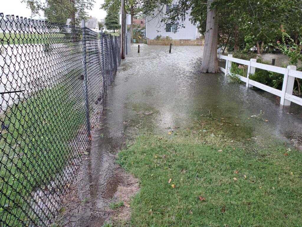 a flooded yard with a fence (MyCoast AI)