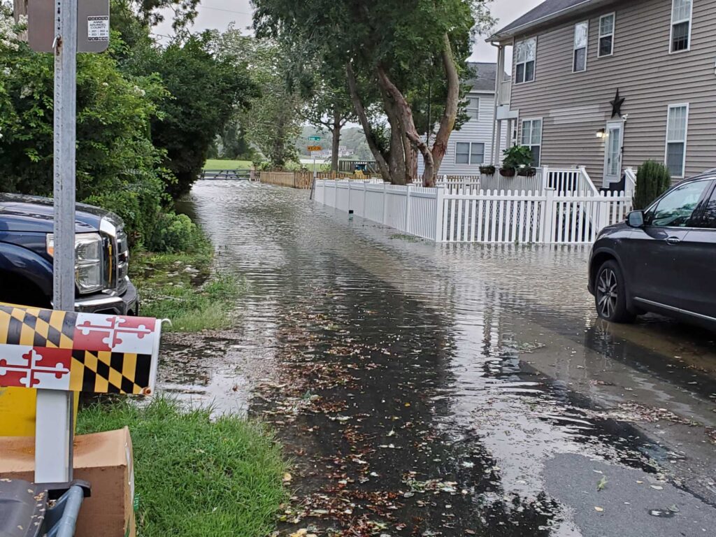 a flooded street with cars and houses (MyCoast AI)