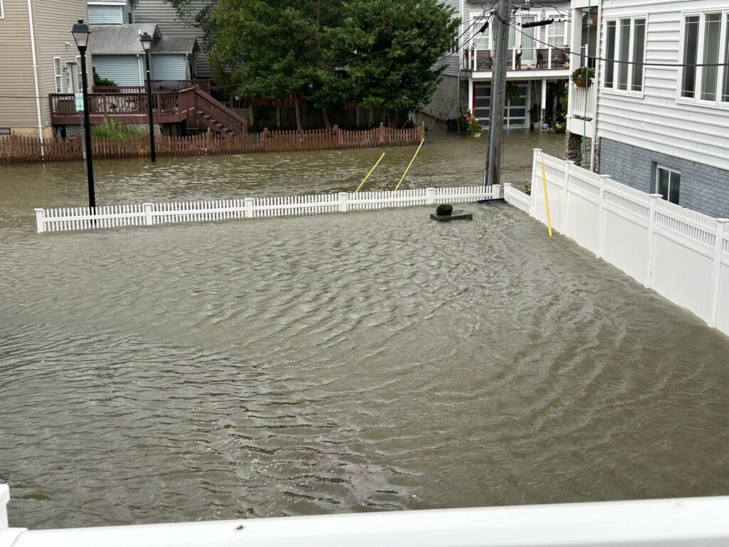 a flooded street with buildings and trees (MyCoast AI)