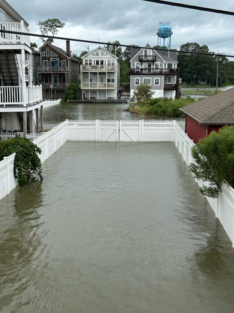 a flooded street with houses on either side of it (MyCoast AI)