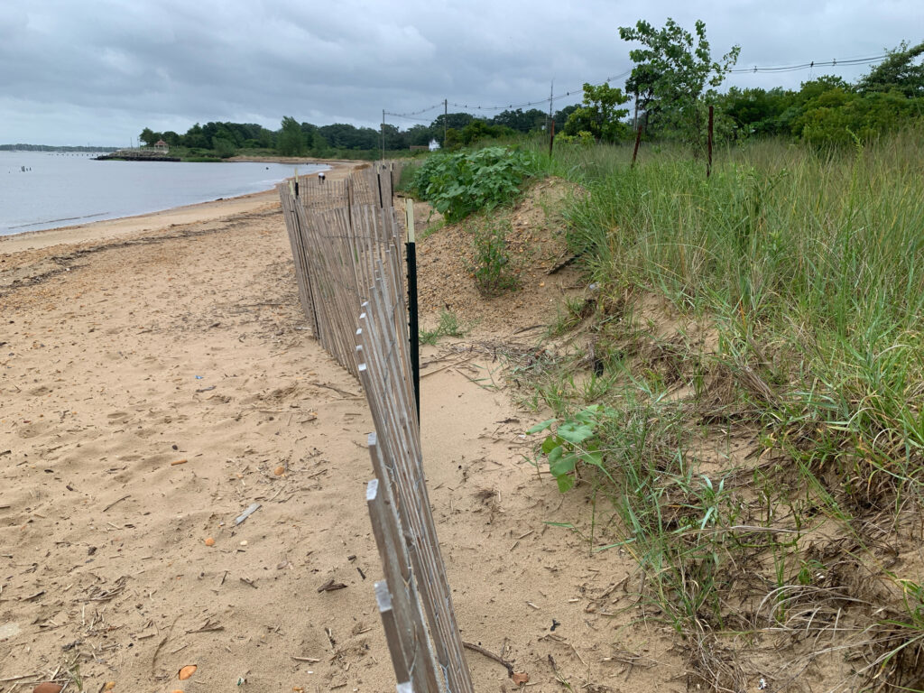 a wooden fence on a beach (MyCoast AI)