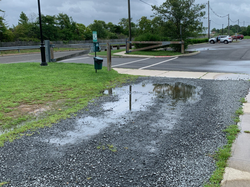 a puddle of water on a road (MyCoast AI)
