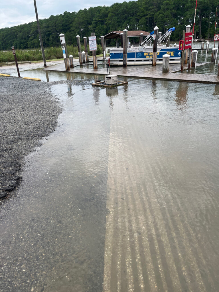 a flooded road with a boat (MyCoast AI)