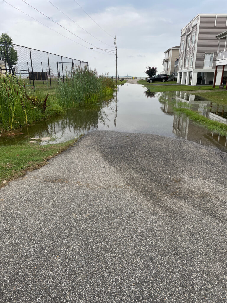 a flooded street with a car parked on the side (MyCoast AI)