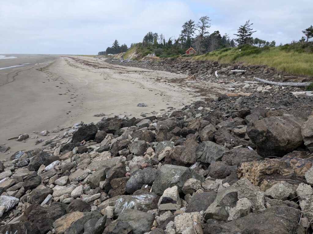 a rocky beach with a red house (MyCoast AI)