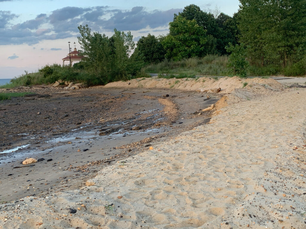 a beach with a house in the background (MyCoast AI)