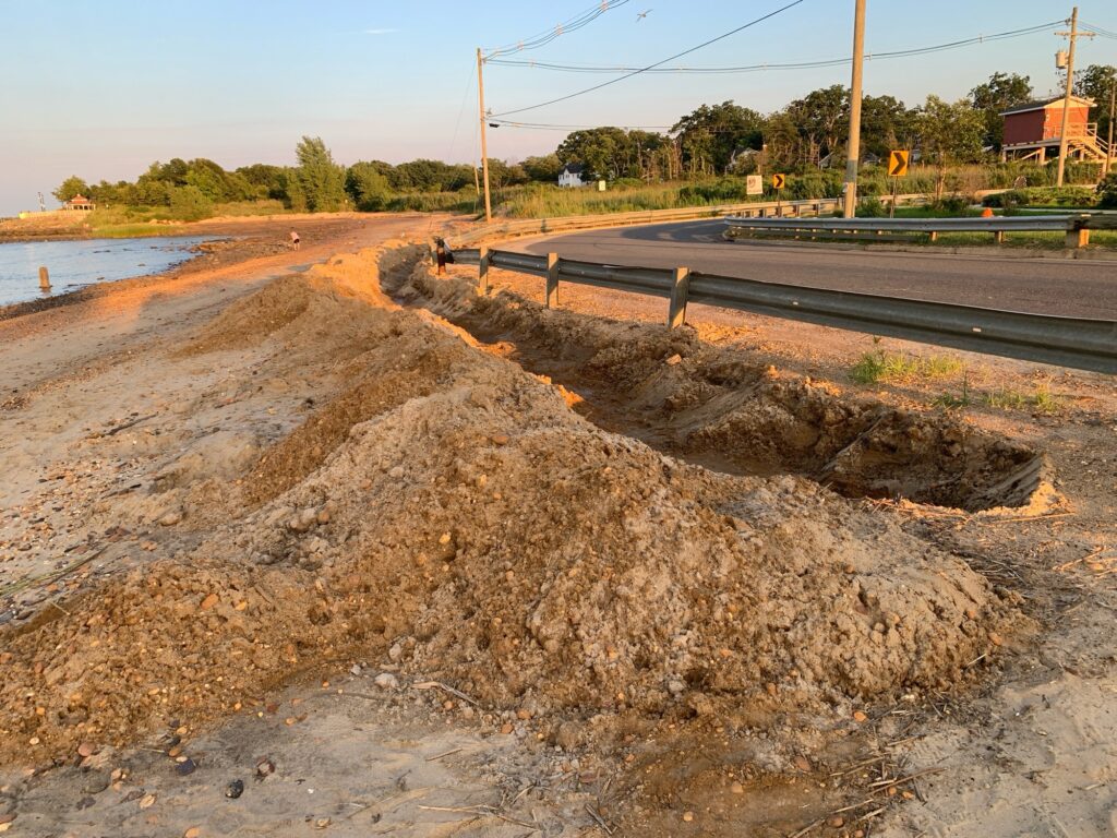 a road with a pile of dirt on the side (MyCoast AI)