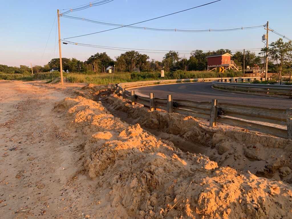 a road with a ditch and a fence (MyCoast AI)