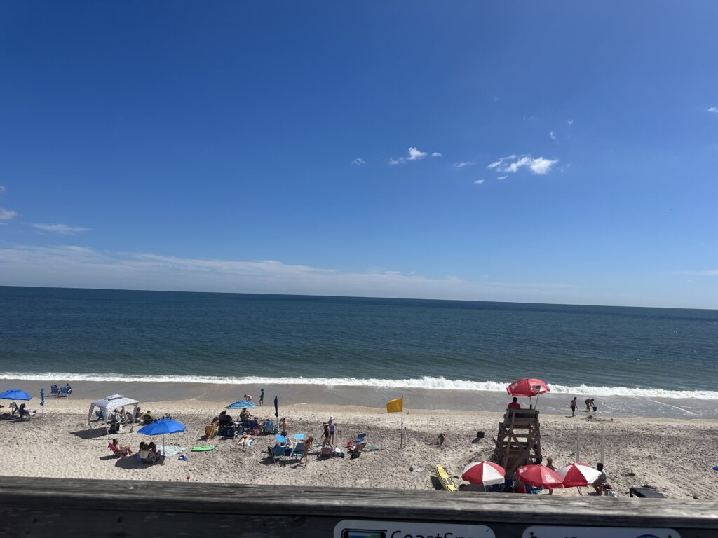 a beach with people and umbrellas (MyCoast AI)