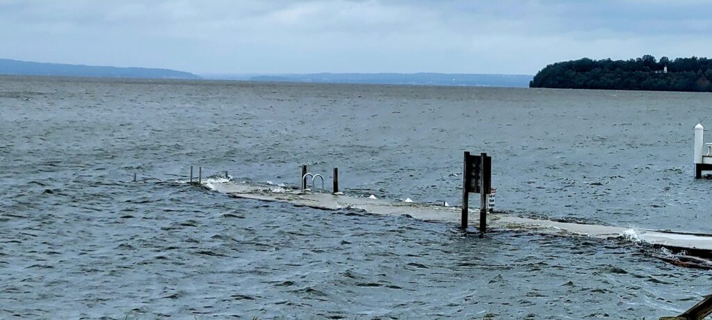 a large body of water with a dock and a small structure in it (MyCoast AI)