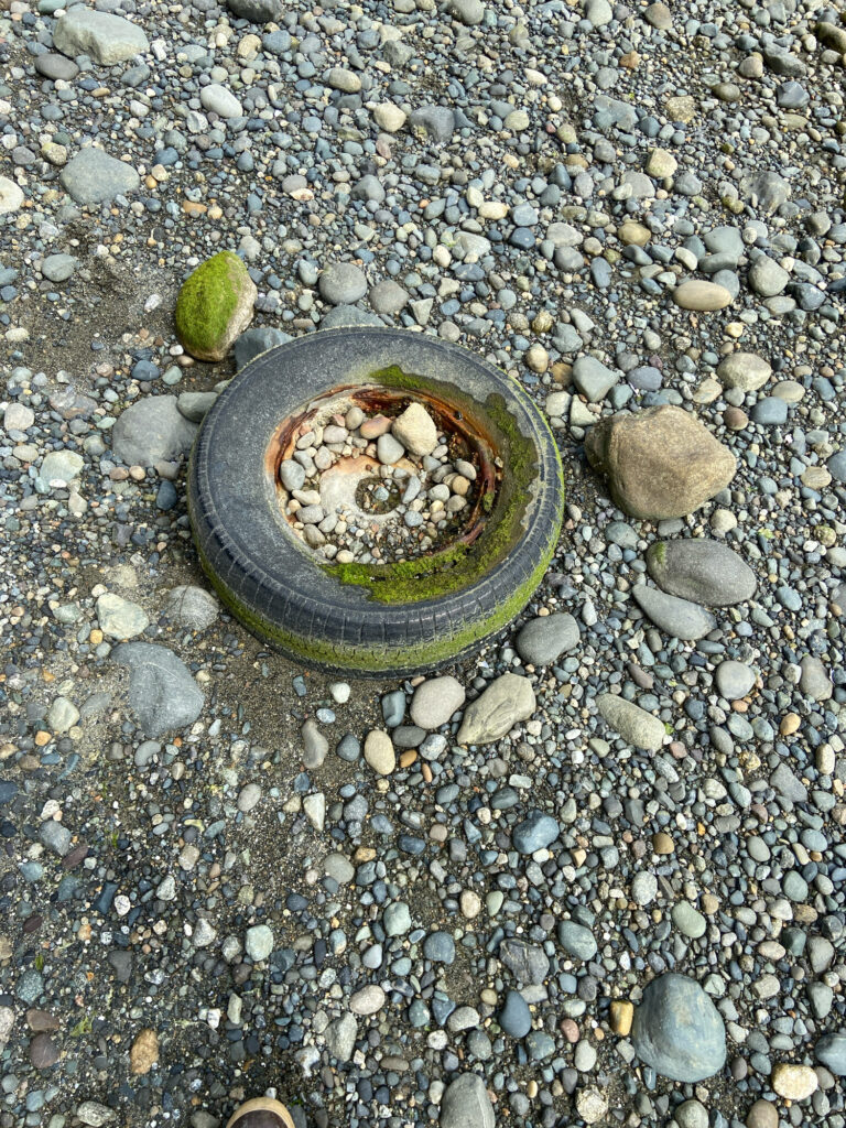 a black bucket on a rocky surface (MyCoast AI)