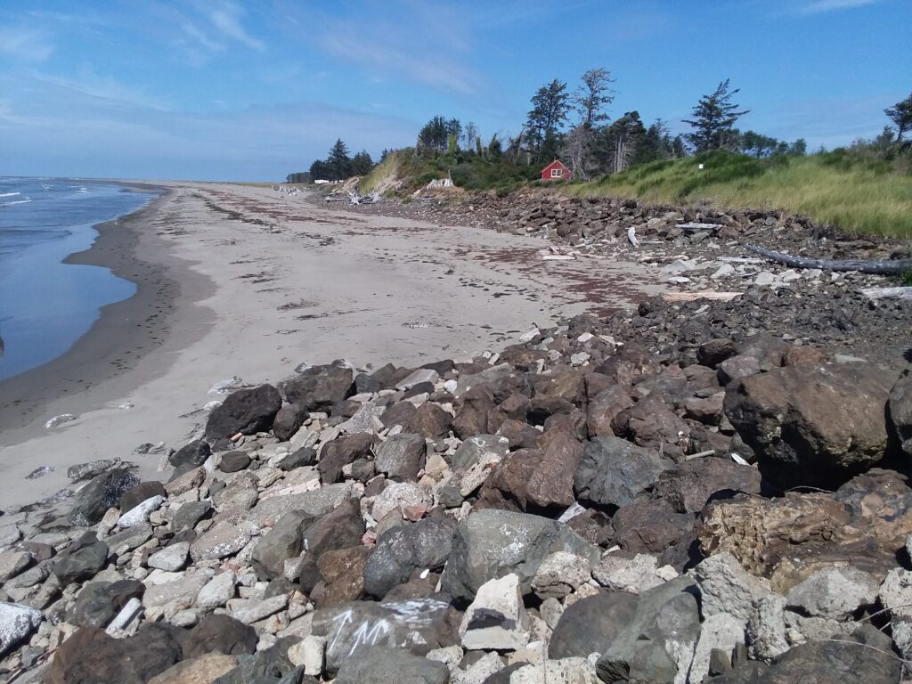 a rocky beach with a red house (MyCoast AI)