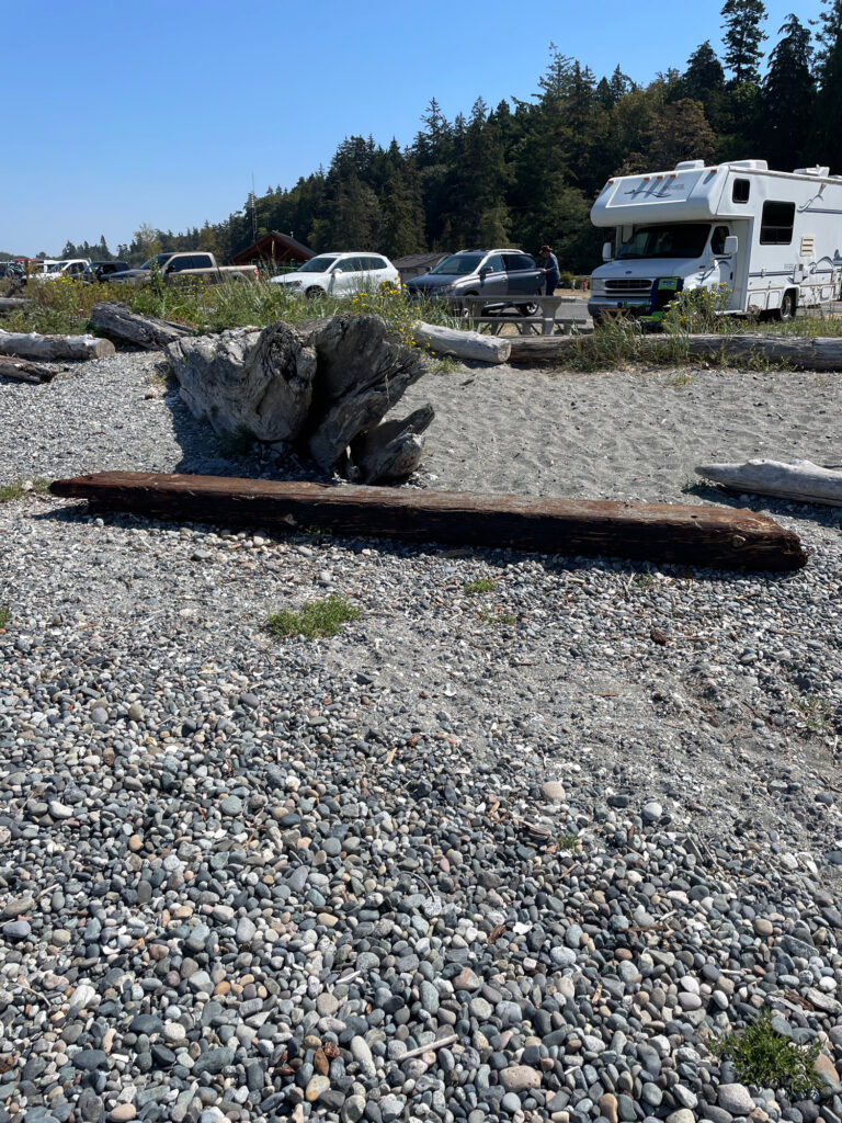 a rocky area with a few vehicles parked in the background (MyCoast AI)
