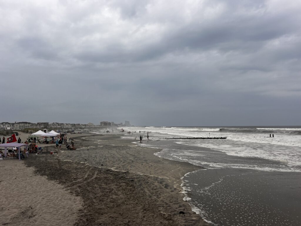 a beach with people and tents (MyCoast AI)