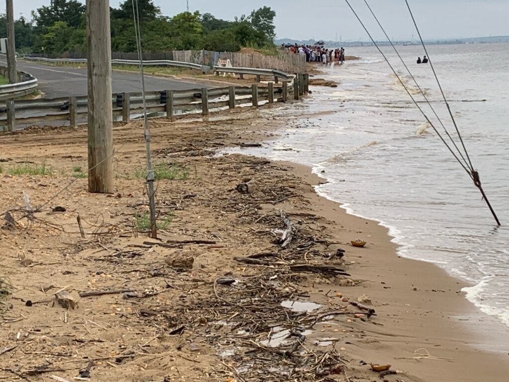 a beach with a pier and a group of people (MyCoast AI)