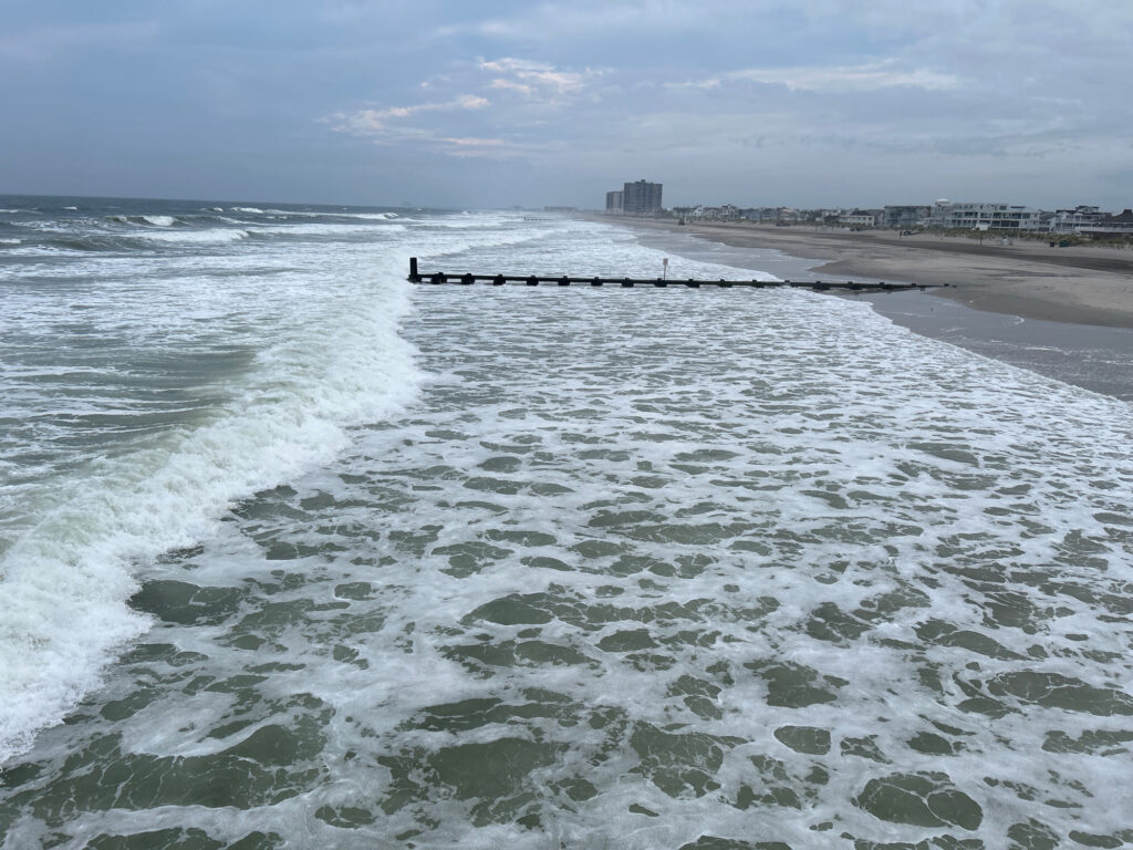 a beach with waves crashing on it (MyCoast AI)