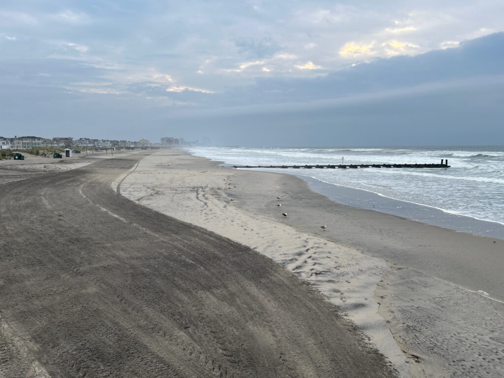 a sandy beach with waves crashing on it (MyCoast AI)