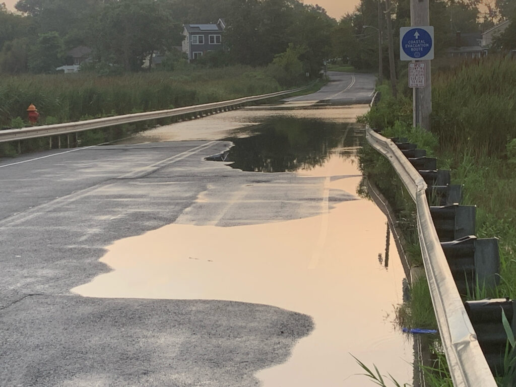 a flooded road with a sign (MyCoast AI)