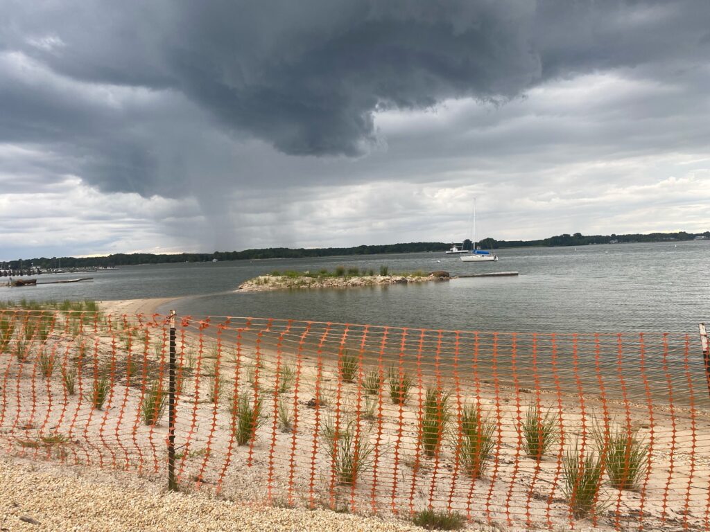 a body of water with boats in it and a cloudy sky above (MyCoast AI)