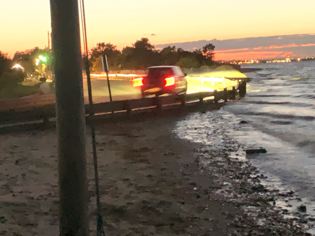 a car on a road with a sunset in the background (MyCoast AI)