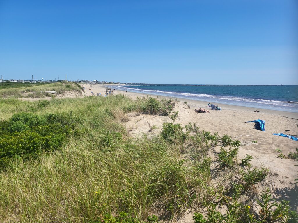 a beach with people and tents (MyCoast AI)