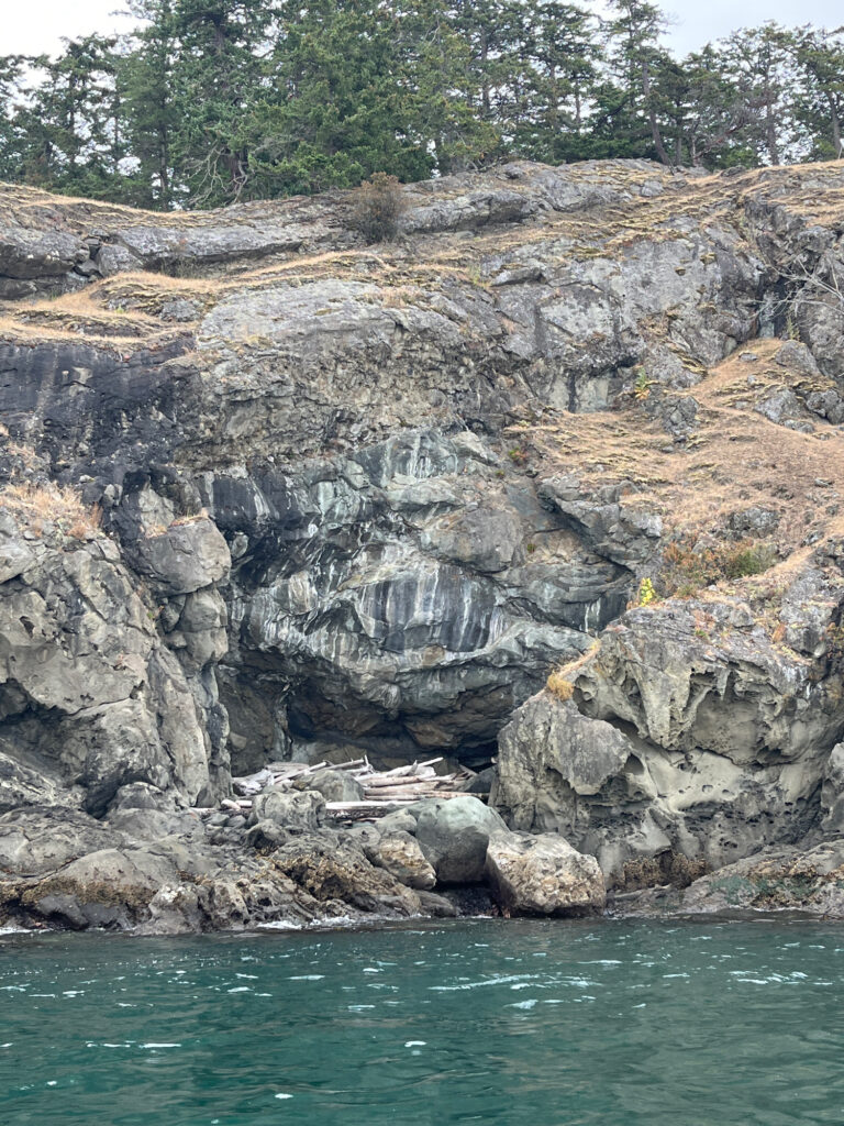 a rocky cliff next to a body of water (MyCoast AI)