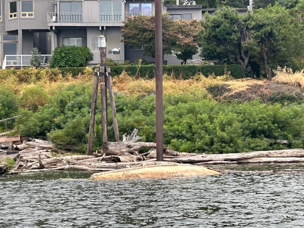 a building with a large pile of wood in front of it (MyCoast AI)
