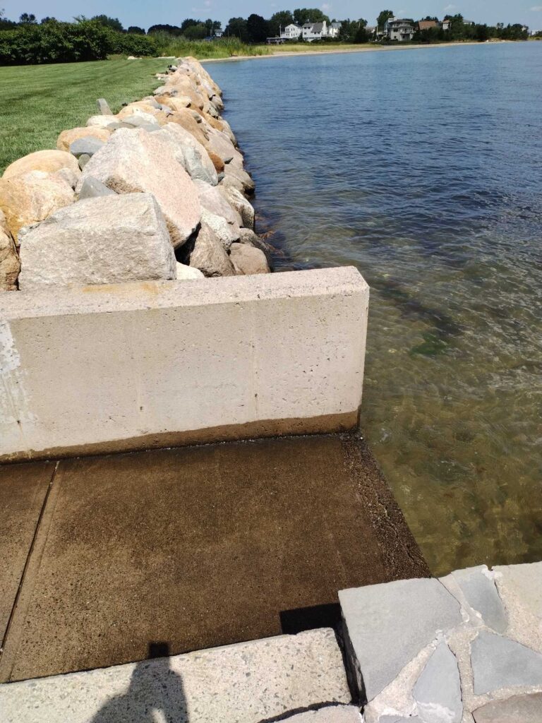 a group of rocks by a body of water (MyCoast AI)