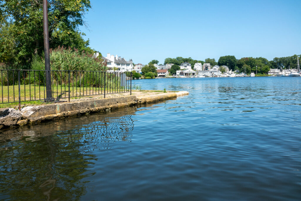 a body of water with a fence and trees around it (MyCoast AI)