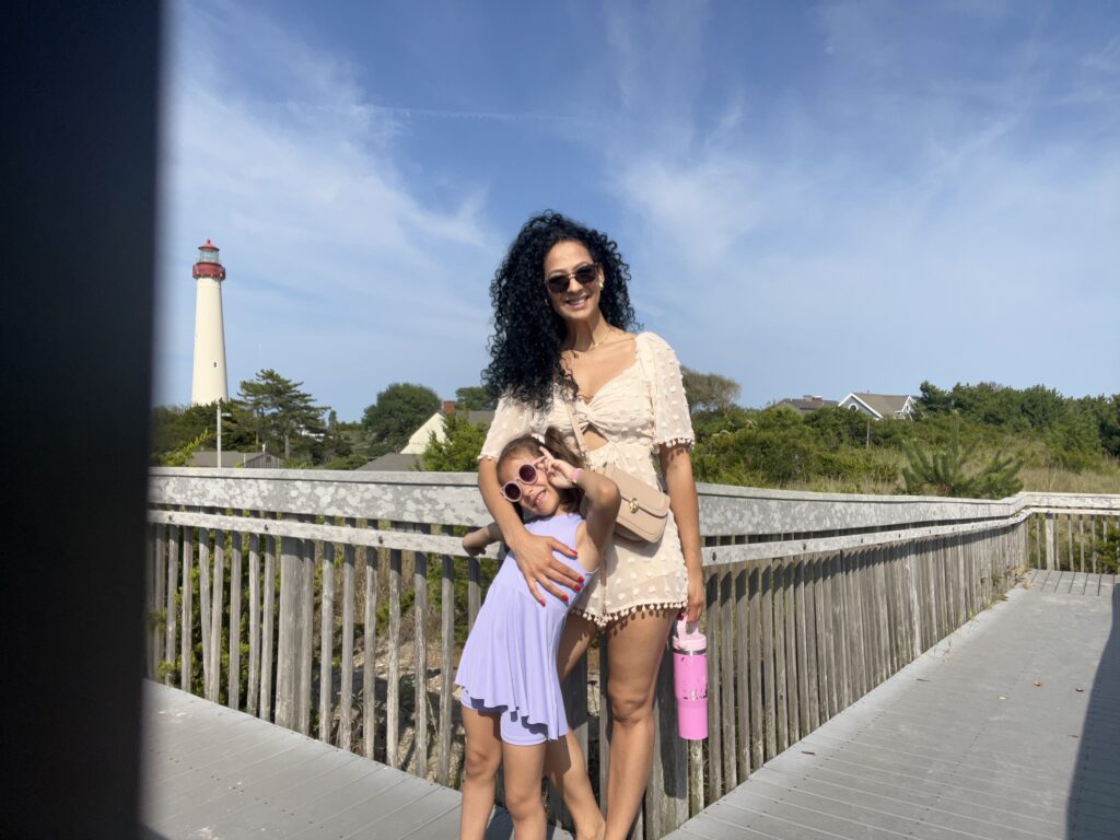 a woman holding a baby on a bridge (MyCoast AI)