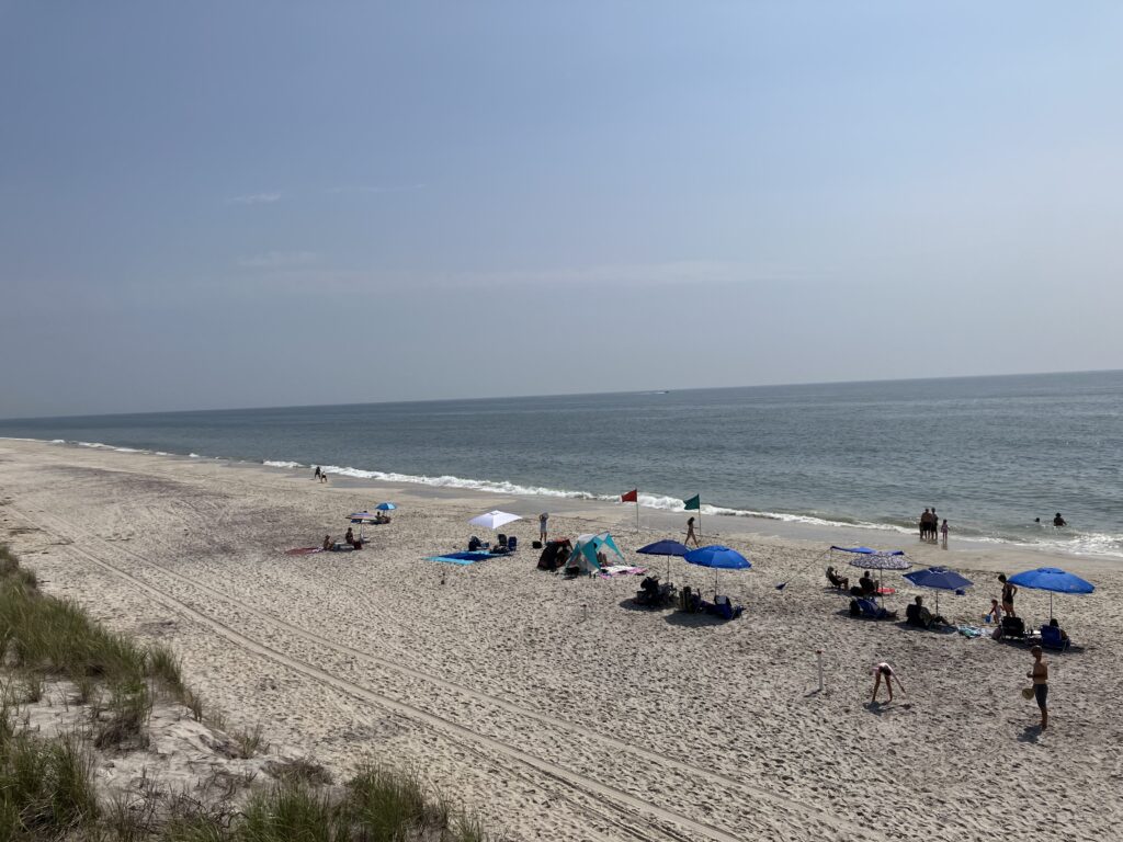 a beach with people and umbrellas (MyCoast AI)