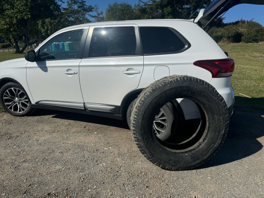 a white car with a flat tire (MyCoast AI)