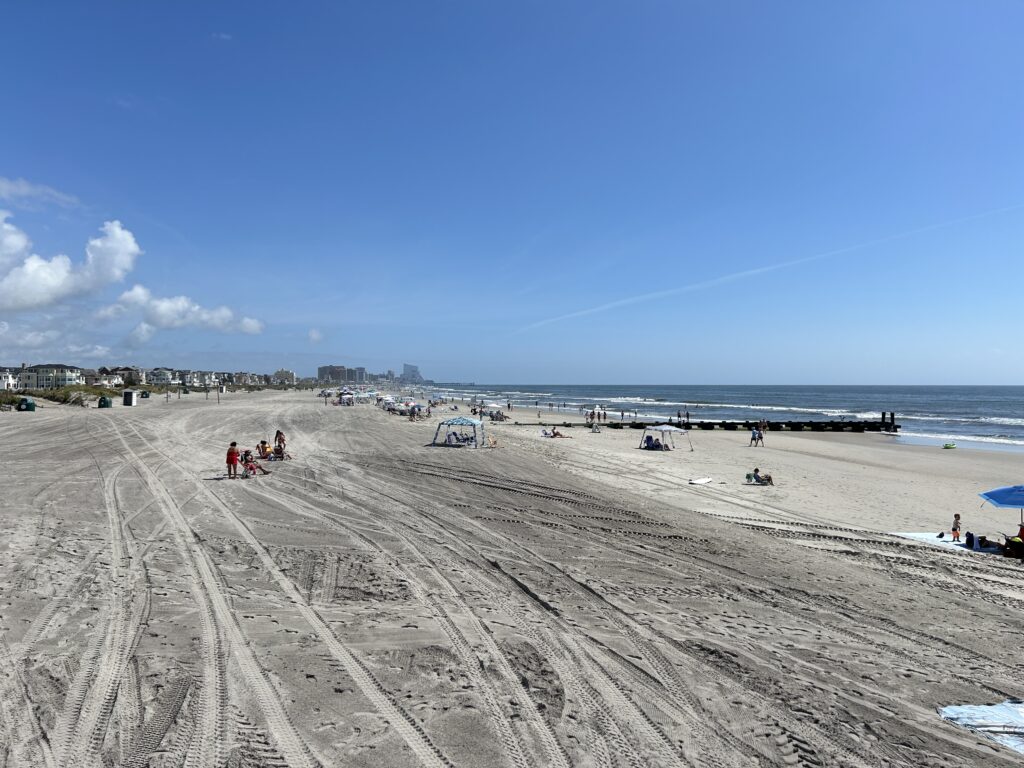 a sandy beach with people and cars (MyCoast AI)